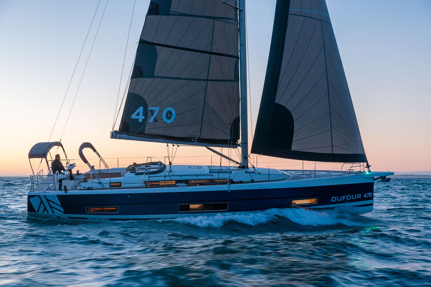 Dufour 470 under sail at sunset, builder photo