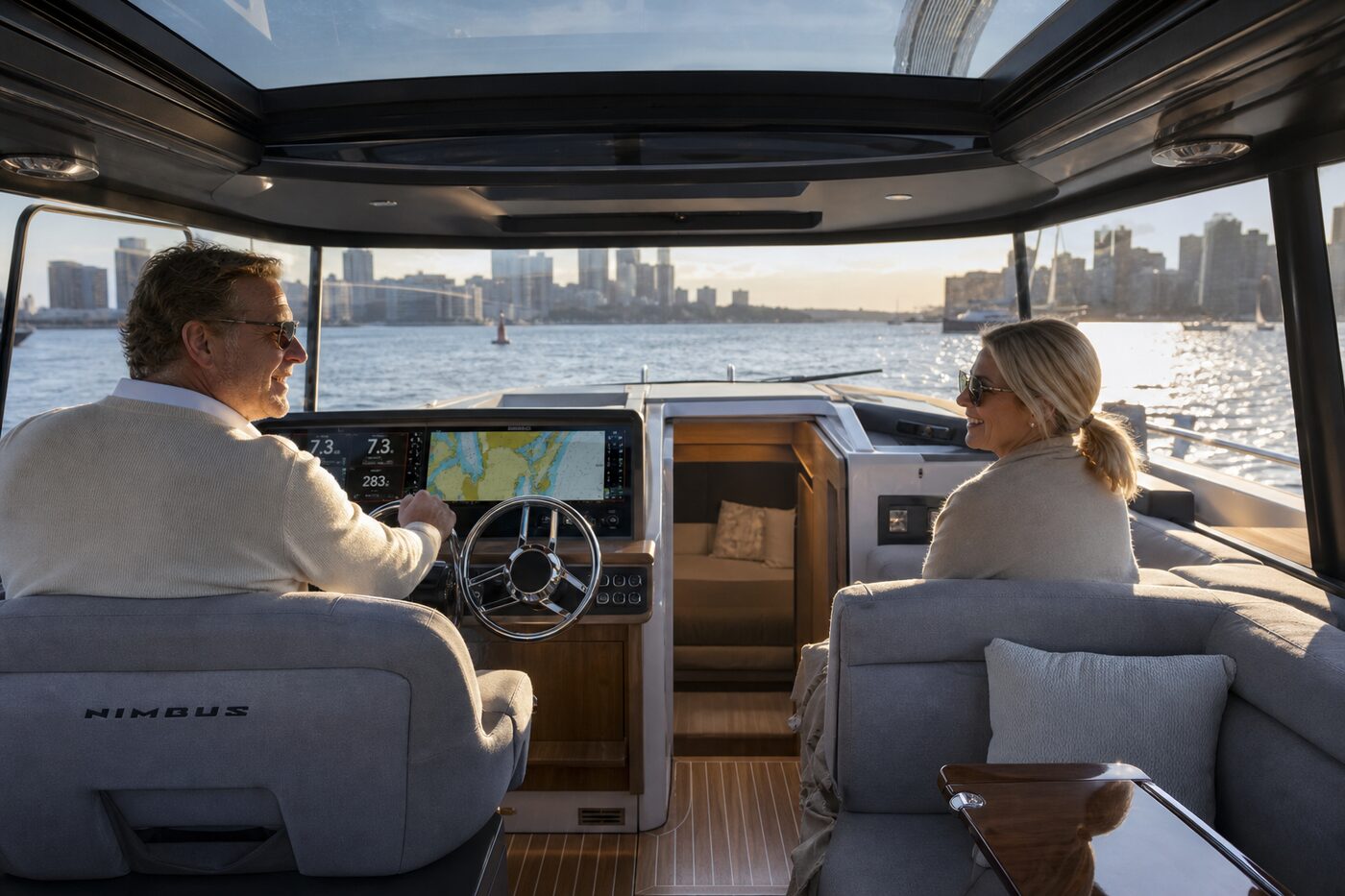 People relaxing in the enclosed cockpit of a boat in Boston Harbor